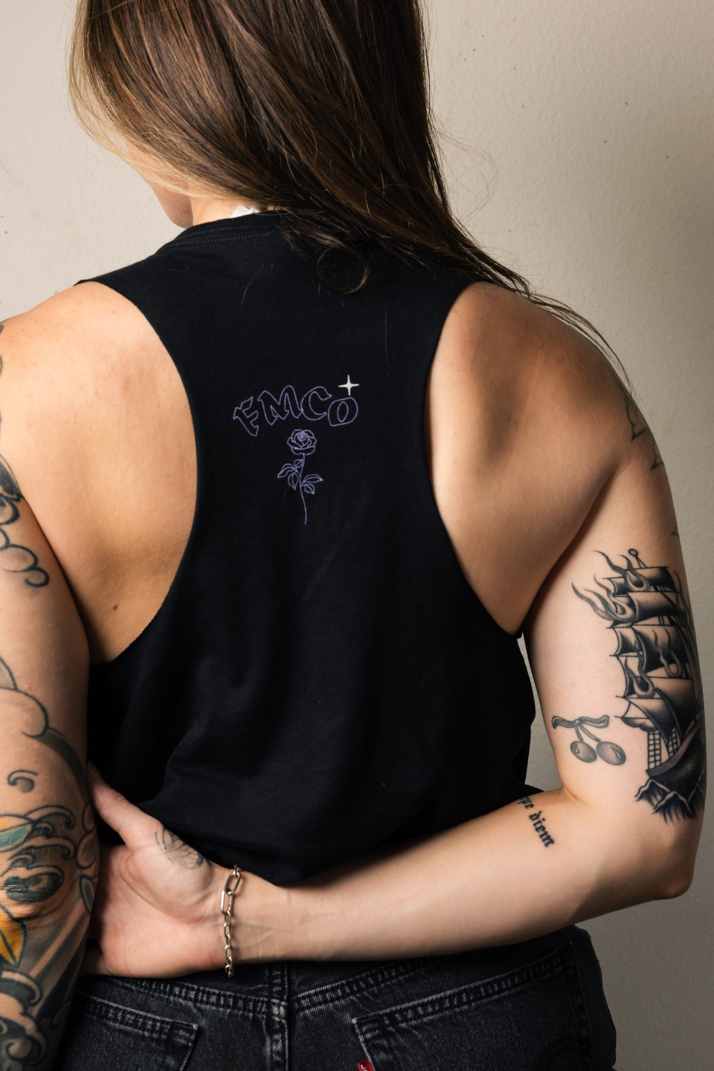 back details of the tank top that have a rose and the letters FMCO