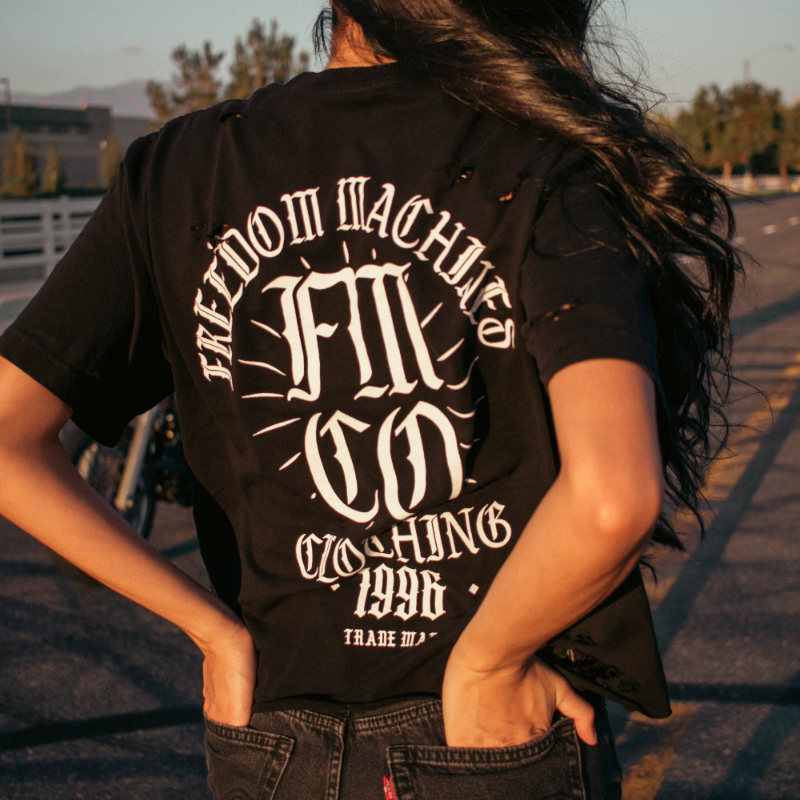 Freedom Machine Women's Black Shirt with white text, small logo on front right, large FMCO on back distressed crop top in sizes small through two extra large