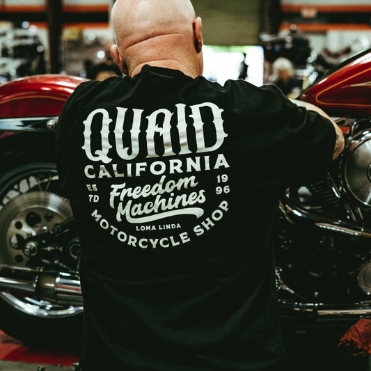 Mens 100% cotton pre shrunk shirt in black with white writing in script "Quaid California Freedom Machines Motorcycle shop" estd 1996 small logo on front left chest