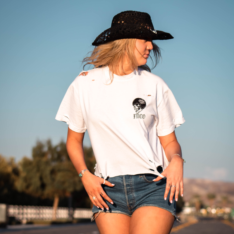 Freedom Machine Women's white crop top with small skull and helmet on front and large skull and helmet on back hand distressed and cropped available in sizes small through two extra large